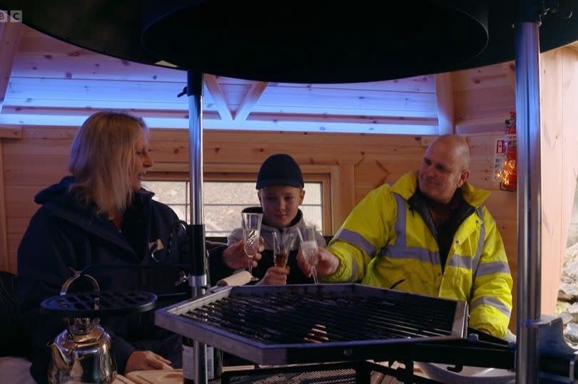 'Cheers to Anglesey'  -Mike and Sarah and their son raise a toast to living on the island