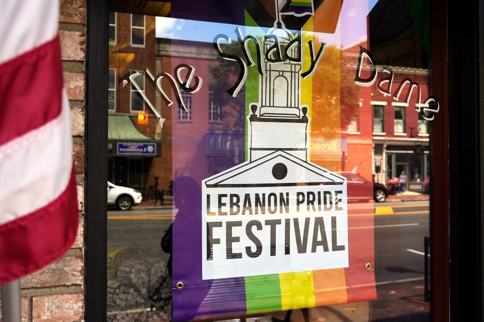 Businesses that support Lebanon Pride hang banners in their windows.