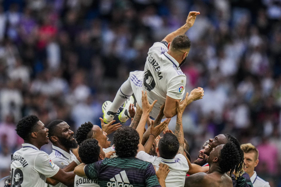 Real Madrid's Karim Benzema is thrown in the air by teammates after their Spanish La Liga soccer match against Athletic Bilbao at the Santiago Bernabeu stadium in Madrid, Sunday, June 4, 2023. (AP Photo/Bernat Armangue)