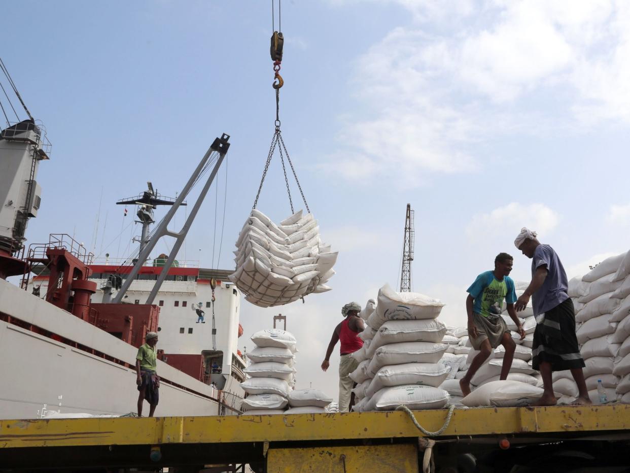 Workers unload wheat assistance provided by Unicef from a cargo ship at the Red Sea port of Hodeidah in January: AFP/Getty