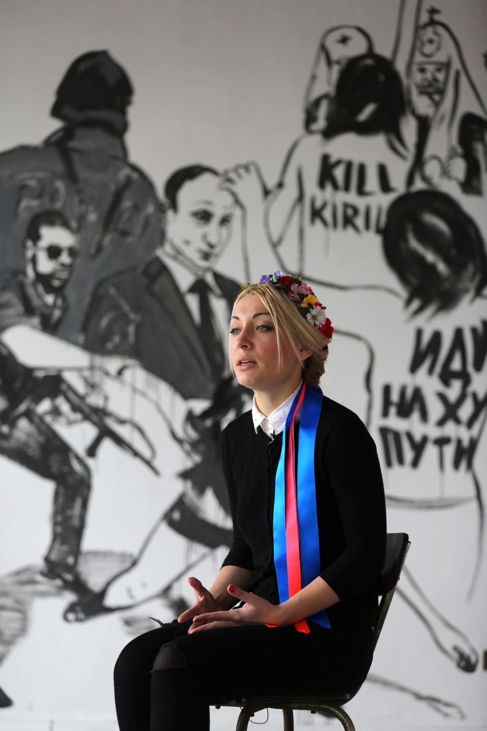 Ukrainian feminist group Femen leader Inna Shevchenko, answers questions from reporters during an interview with the Associated Press in a Paris suburb, Tuesday Feb. 18, 2014. Nine activists from the topless women’s protest movement Femen will face court in February over charges that they damaged Notre Dame cathedral during a demonstration last year.(AP Photo/Remy de la Mauviniere)