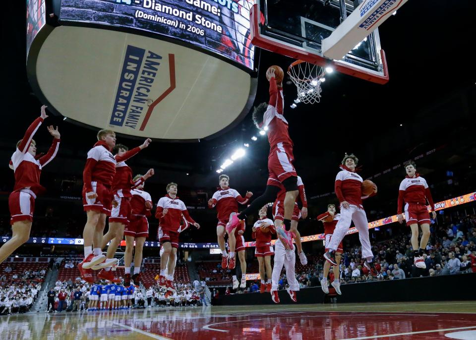 Neenah High School players leap in unison at the end of their warm-up period before the WIAA Division 1 state championship boys basketball game on Saturday, March 19, 2022, at the Kohl Center in Madison, Wis. Neenah defeated Brookfield Central High School, 64-52.Tork Mason/USA TODAY NETWORK-Wisconsin 