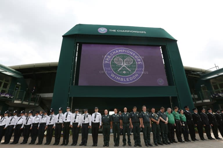 Members of the emergency services at Wimbledon observe a minute's silence in memory of the 52 people who were killed in the 2005 London suicide bombings on June 7, 2015