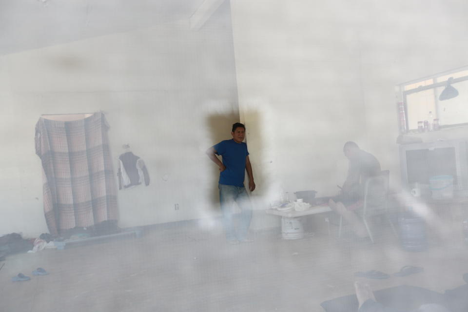 Photographed through a window screen, Central American migrants pass the time at the Pan de Vida shelter in Ciudad Juarez, Mexico, while waiting for their turn to request asylum in the United States, Thursday, Sept. 12, 2019. Mexican Foreign Secretary Marcelo Ebrard said Thursday that Mexico's government doesn't agree with an "astonishing" U.S. Supreme Court order that would block migrants from countries other than Mexico and Canada from applying for asylum at U.S. borders.(AP Photo/Christian Chavez)