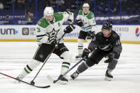 Dallas Stars' John Klingberg, left, avoids a check from Tampa Bay Lightning's Ondrej Palat during the first period of an NHL hockey game Saturday, Feb. 27, 2021, in Tampa, Fla. (AP Photo/Mike Carlson)