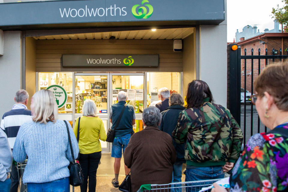 Elderly people are seen waiting for the opening of Woolworths supermarket in Balmain.