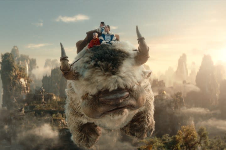 Aang, Sokka, and Katara ride on Appa in Avatar: The Last Airbender.