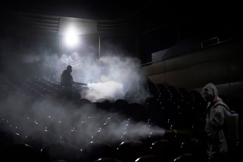 Volunteers from the Blue Sky Rescue team disinfect at the Qintai Grand Theatre in Wuhan