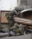 Government soldiers aim their weapons towards the position of Muslim rebels during a battle in downtown Zamboanga September 11, 2013. (REUTERS/Erik De Castro)