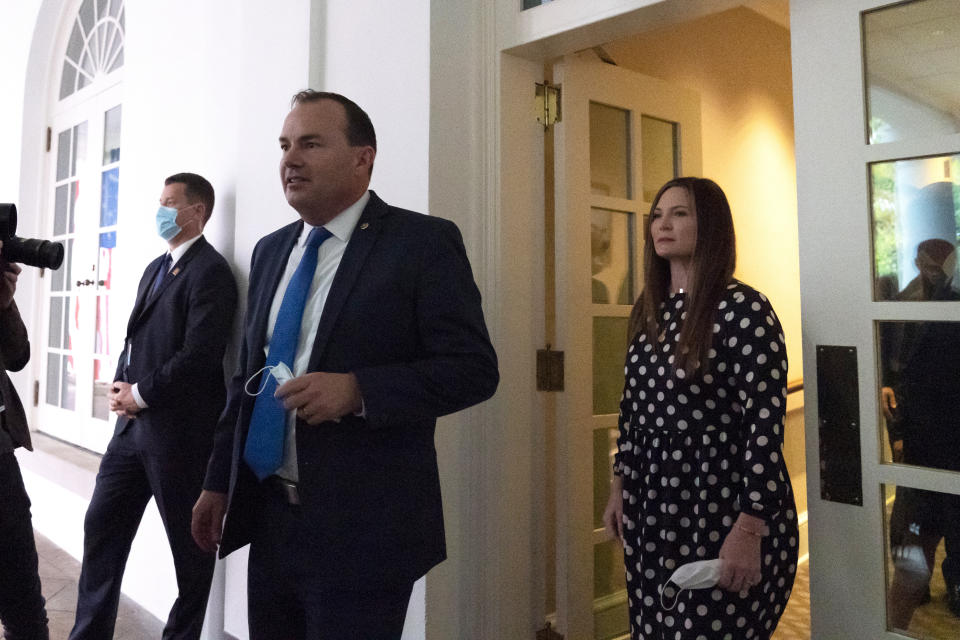 In this Saturday, Sept. 26, 2020, photo, Sen. Mike Lee, R-Utah, center, steps out of the West Wing to watch as President Donald Trump announces Judge Amy Coney Barrett as his nominee to the Supreme Court, in the Rose Garden at the White House in Washington. (AP Photo/Alex Brandon)