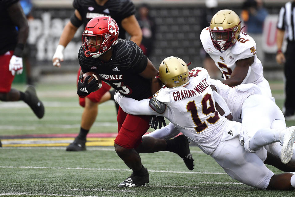 Louisville tight end Marshon Ford (83) is brought down by Boston College linebacker Isaiah Graham-Mobley (19) during the first half of an NCAA college football game in Louisville, Ky., Saturday, Oct. 23, 2021. (AP Photo/Timothy D. Easley)