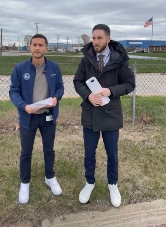 In a screengrab from a livestream by the city of Dearborn, Dearborn Mayor Abdullah Hammoud, right, and Dearborn Public Health Director Ali Abazeed speak on April 18, 2023, outside Pro V, a Dearborn scrapyard, announcing a city lawsuit filed against Pro V over dust pollution.