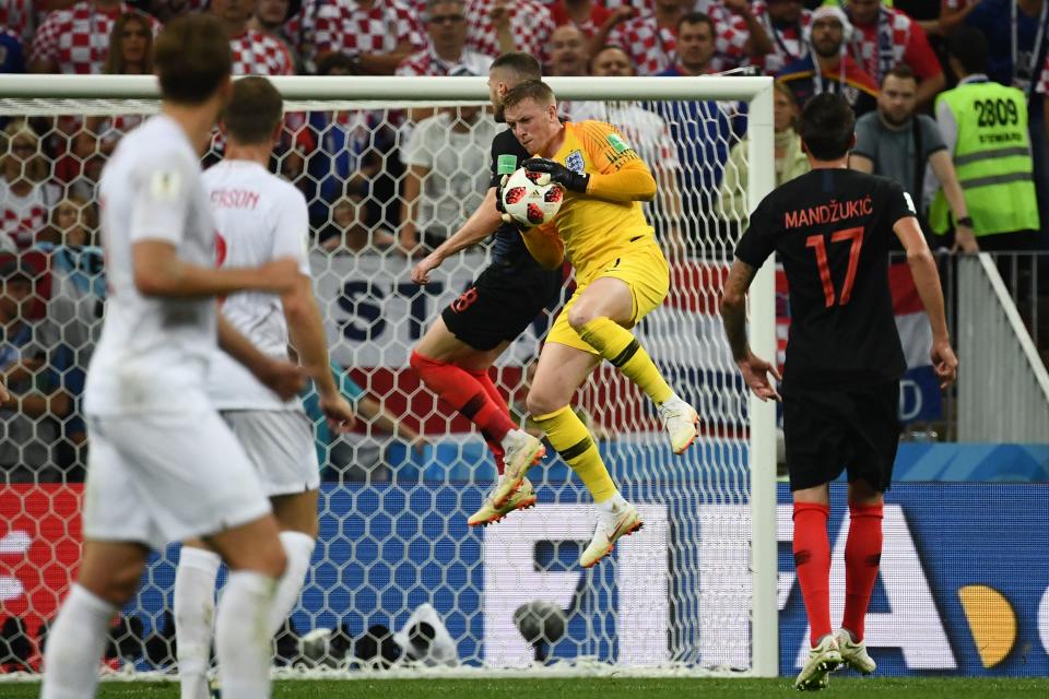 <p>England’s goalkeeper Jordan Pickford (2nd-R) catches the ball ahead of Croatia’s forward Ante Rebic (C) during the Russia 2018 World Cup semi-final football match between Croatia and England at the Luzhniki Stadium in Moscow on July 11, 2018. (Photo by FRANCK FIFE / AFP) </p>