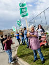 Susan Donovan, of Davison, stands outside of the Flint Assembly Plant as General Motors employees demonstrate on Sunday, Sept. 15, 2019, in Flint, Mich. The United Auto Workers union says its contract negotiations with GM have broken down and its members will go on strike just before midnight on Sunday. (Jake May/The Flint Journal via AP)