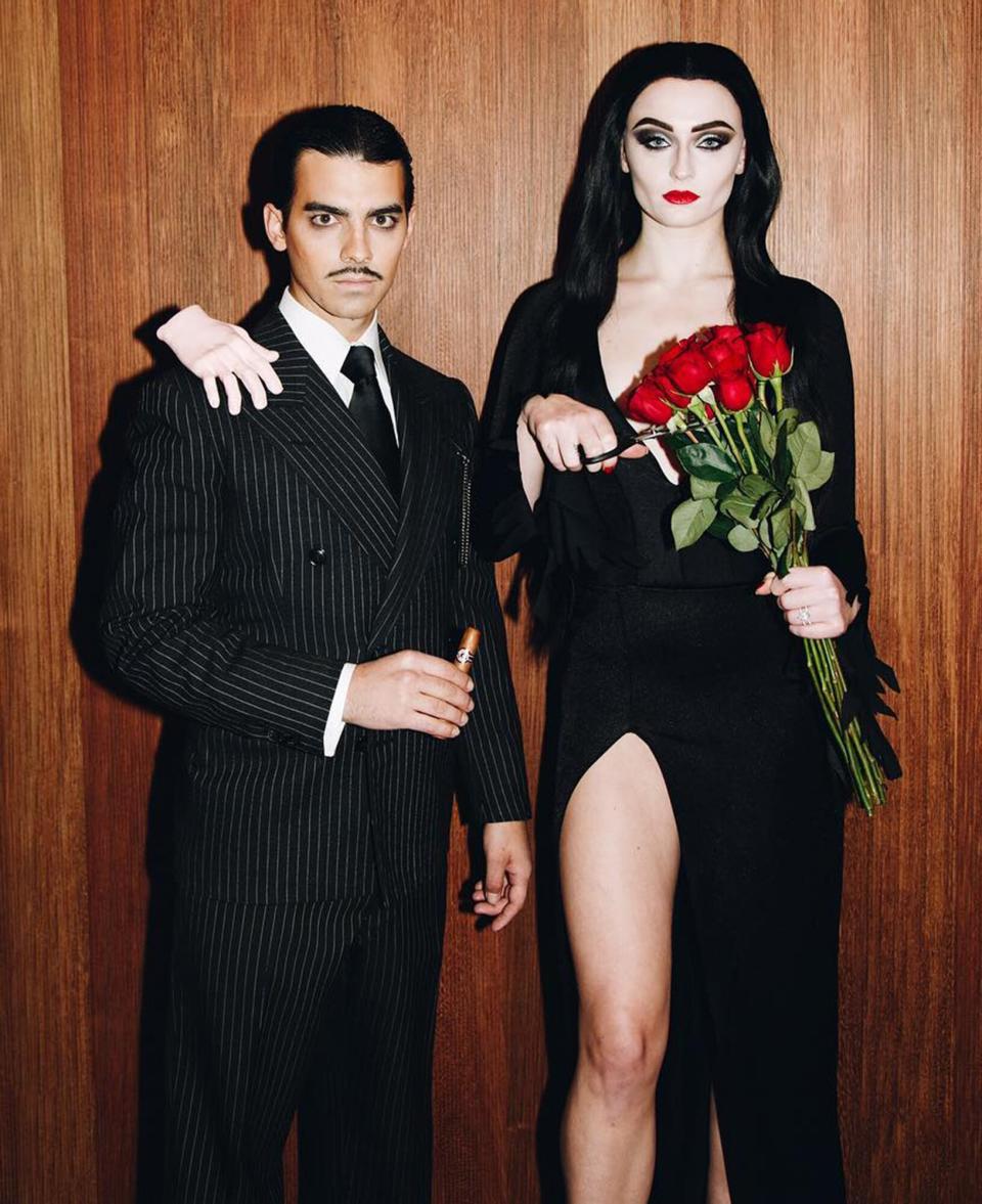 Sophie Turner and Joe Jonas dressed as Morticia and Gomez Addams
