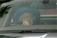 <p>Almost hidden behind the steering wheel, Queen Elizabeth drove her Jaguar to the Credit Suisse Royal Windsor Cup Final at Guards Polo Club. </p>