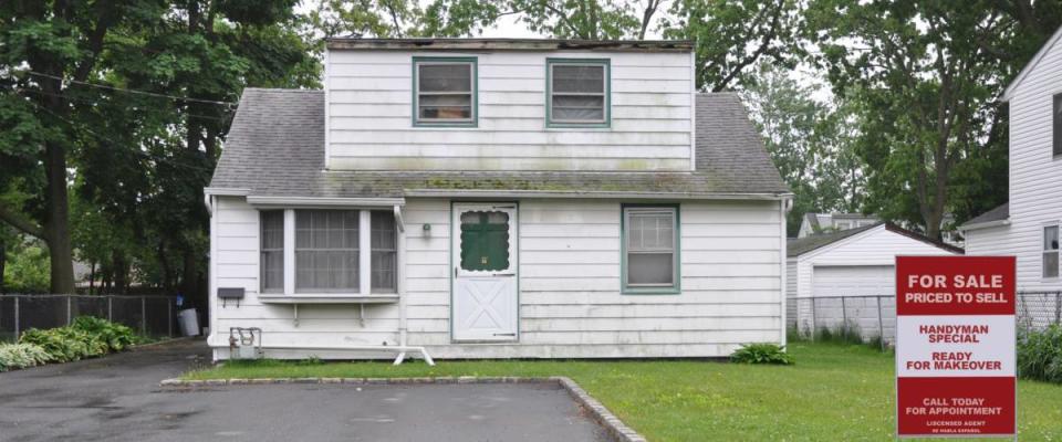 Real Estate Realtor For Sale Sign Handyman Special Bungalow Home in bad condition with Dormer Extension