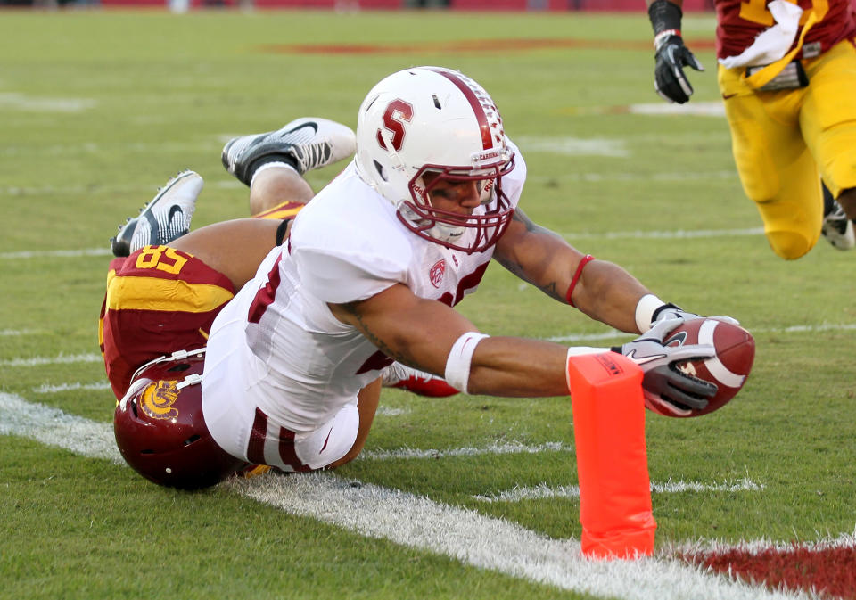 LOS ANGELES, CA - OCTOBER 29: Running back Tyler Gaffney #25 of the Stanford Cardinal reaches the ball over the goal line to score on a ten yard touchdown rececption in the first quarter against defensive tackle J.R. Tavai #58 of the USC Trojans at the Los Angeles Memorial Coliseum on October 29, 2011 in Los Angeles, California. (Photo by Stephen Dunn/Getty Images)