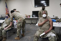 FILE - In this Dec. 23, 2020, file photo, members of the Mississippi Air and Army National Guard Guard receive the first dose of the Moderna COVID-19 vaccine in Flowood, Miss. The coronavirus vaccines have been rolled out unevenly across the U.S., but some states in the Deep South have had particularly dismal inoculation rates. (AP Photo/Rogelio V. Solis, File)