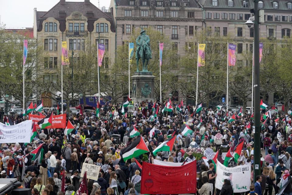 Protesters gather in Sweden near the Malmö Arena as they wave Palestinian flags (Copyright 2024 The Associated Press. All rights reserved)