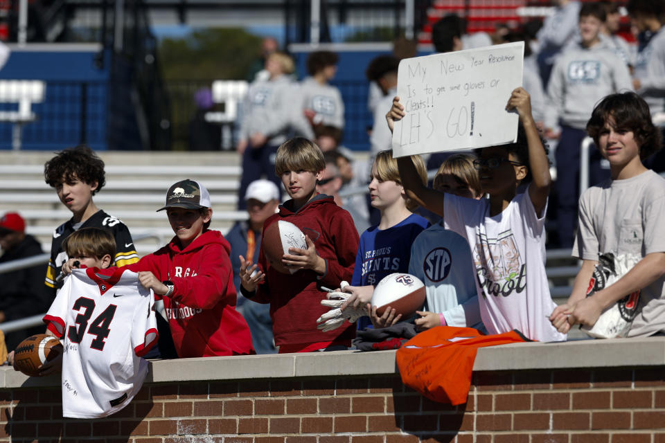 Fans call out to players for autographs during practice for the Senior Bowl NCAA college football game, Wednesday, Jan. 31, 2024, in Mobile, Ala. (AP Photo/ Butch Dill)