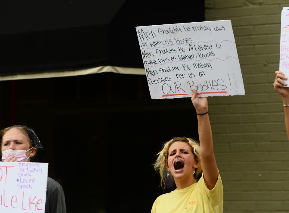 A Pro-choice protest took place on North Church Street in downtown Spartanburg on June 28, 2022.  The protest took place just days after the Supreme Court's reversed the landmark case Roe v. Wade decision issued on January 22, 1973. Isabelle Addis, center holding up,  cheers with other protesters on the sidewalk.