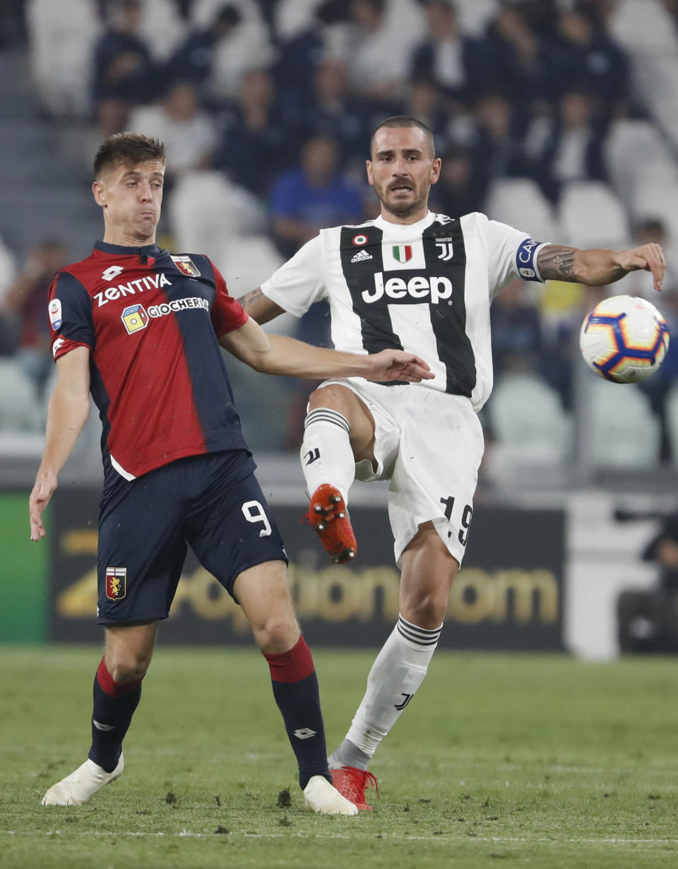 Genoa's Krzysztof Piatek, left, and Juventus' Leonardo Bonucci vie for the ball during an Italian Serie A soccer match between Juventus and Genoa, at the Alliance stadium in Turin, Italy, Saturday, Oct. 20, 2018. (AP Photo/Antonio Calanni)