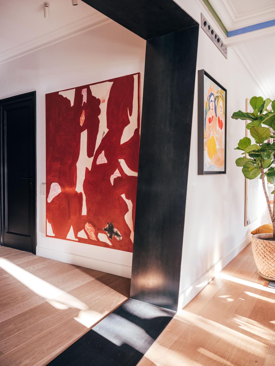 Juan’s apartment is full of off angles and unexpected pairings. When viewed from this vantage point, paintings by Albert Riera Galceran (left) and Faye Wei Wei (right) have a coalescing effect.