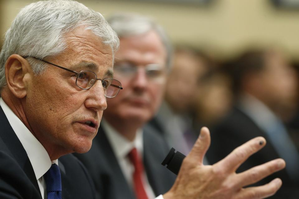 U.S. Defense Secretary Chuck Hagel (L) testifies with Defense Department General Counsel Stephen Preston (2nd L) about the Bergdahl prisoner exchange at a House Armed Services Committee hearing on Capitol Hill in Washington June 11, 2014. Hagel on Wednesday defended Washington's decision to swap five Taliban leaders to win the release of U.S. Army war prisoner Bowe Bergdahl, saying the pledge to recover service members in captivity is "woven into the fabric of our nation." REUTERS/Jonathan Ernst (UNITED STATES - Tags: POLITICS MILITARY)