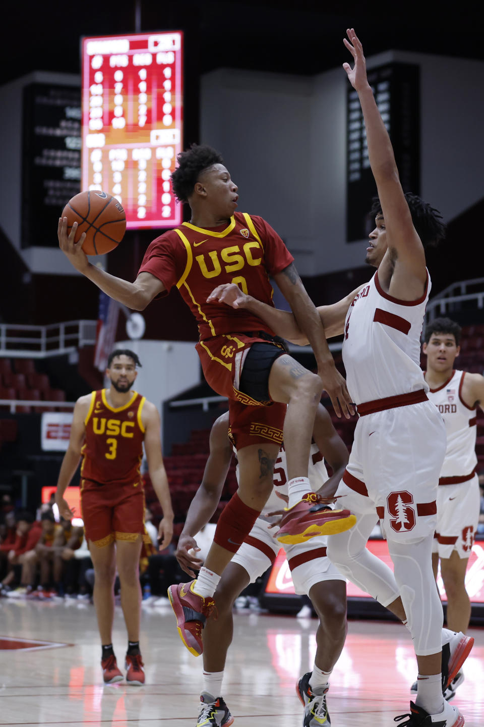 Southern California guard Boogie Ellis (0), left, drives for the basket as Stanford forward Spencer Jones (14), right, defends during the first half of an NCAA college basketball game Tuesday, Jan. 11, 2022, in Stanford, Calif. (AP Photo/Josie Lepe)