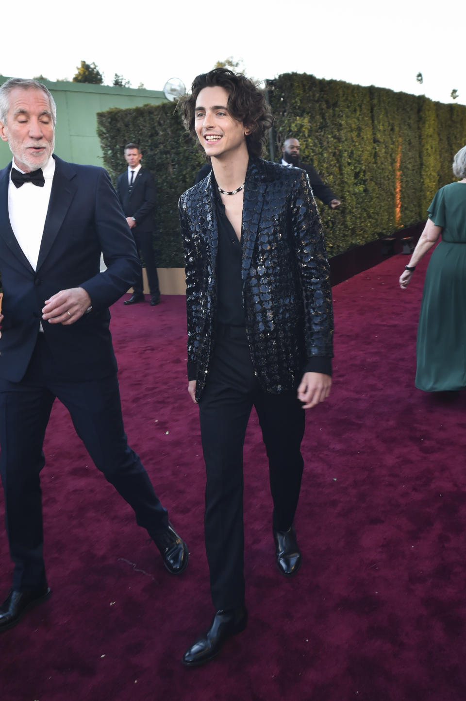 Timothée Chalamet Poses in Black Patent Leather Boots at Golden Globes 2024