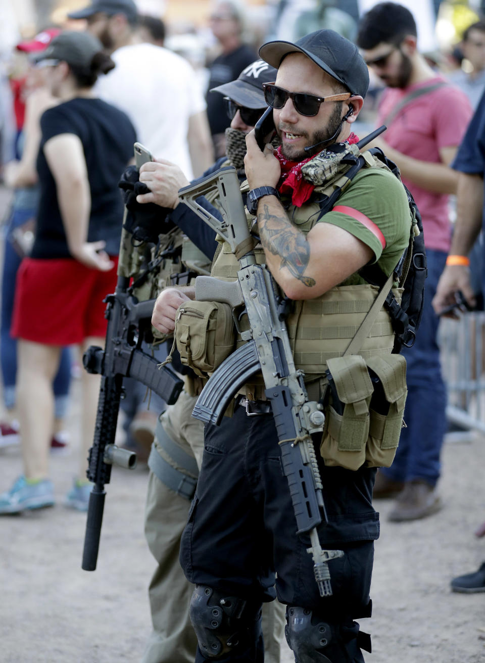 <p>Members of the John Brown Gun Club and Redneck Revolt protest outside the Phoenix Convention Center, Tuesday, Aug. 22, 2017, in Phoenix. Protests were held against President Trump as he hosted a rally inside the convention center. (AP Photo/Matt York) </p>