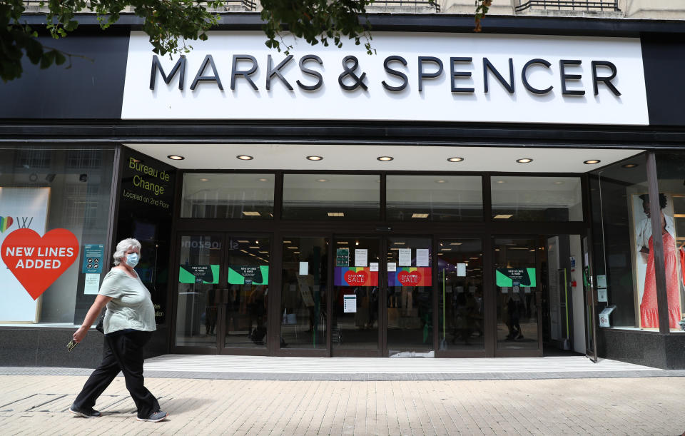 Marks &amp; Spencer A person wearing a face mask makes their way past Marks and Spencer as they walk along Broadmead in Bristol, as face coverings become mandatory in shops and supermarkets in England.