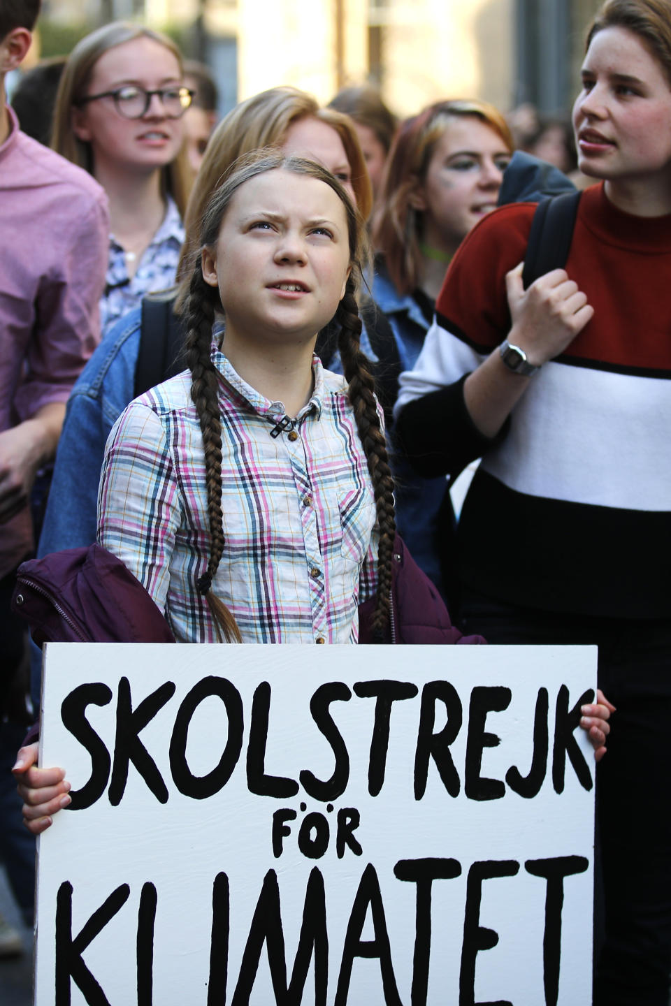 Swedish teenager Greta Thunberg, center, leads a march of thousands of French students through Paris, France, to draw more attention to fighting climate change, Friday, Feb. 22, 2019. Sign reads : "school strike for the climate". (AP Photo/Francois Mori)