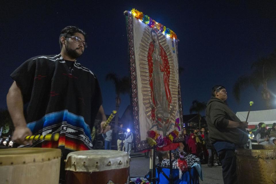 Crowds watch Aztec dancers perform in honor of the Virgen de Guadalupe