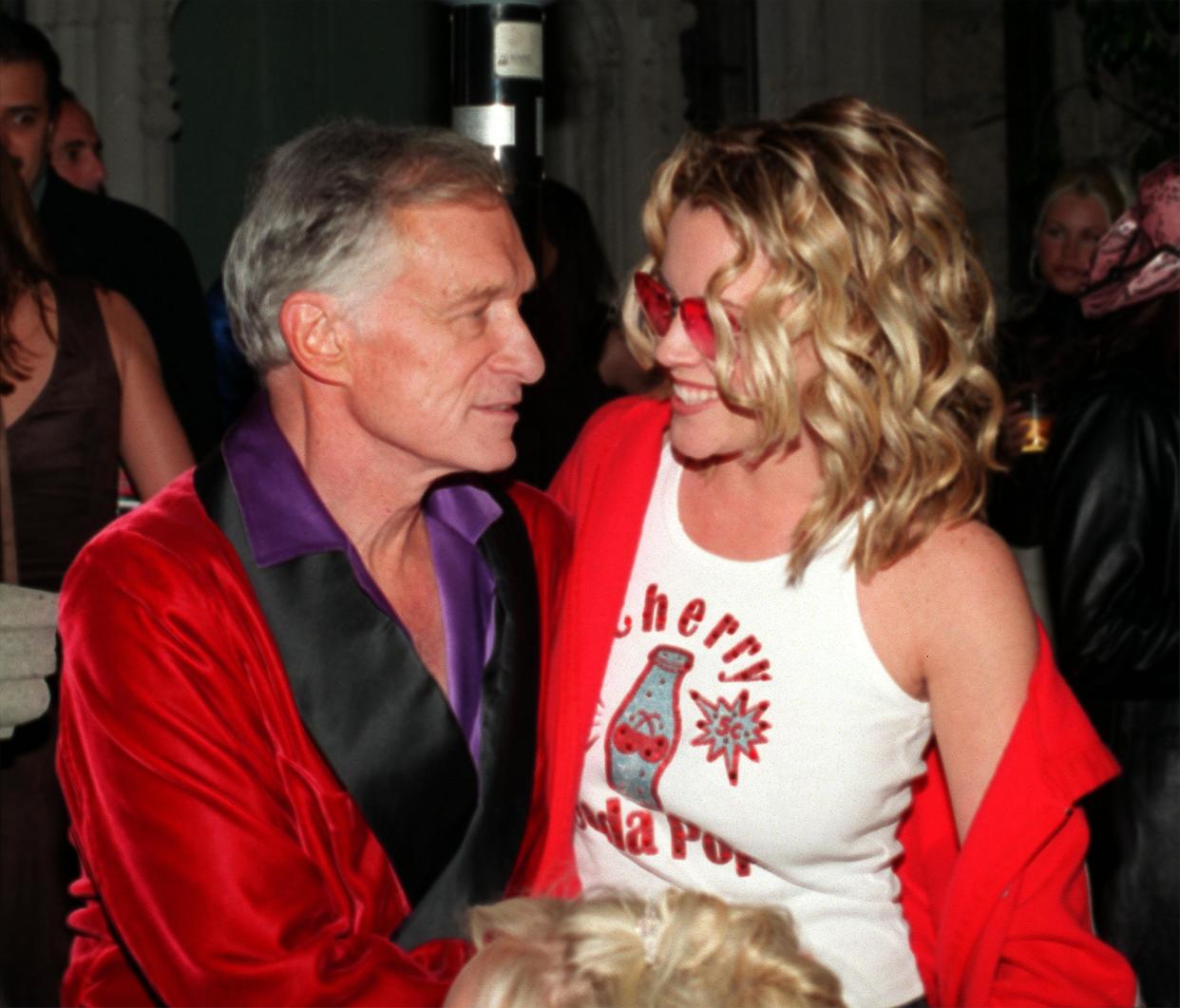 385637 03: Playboy founder Hugh Hefner and actress and former playmate Jenny McCarthy cuddle February 9, 2001 during the Playboy Valentine's Day party at the Playboy Mansion in Bel Air, CA. (Photo by Laurence Cottrell/Liaison)