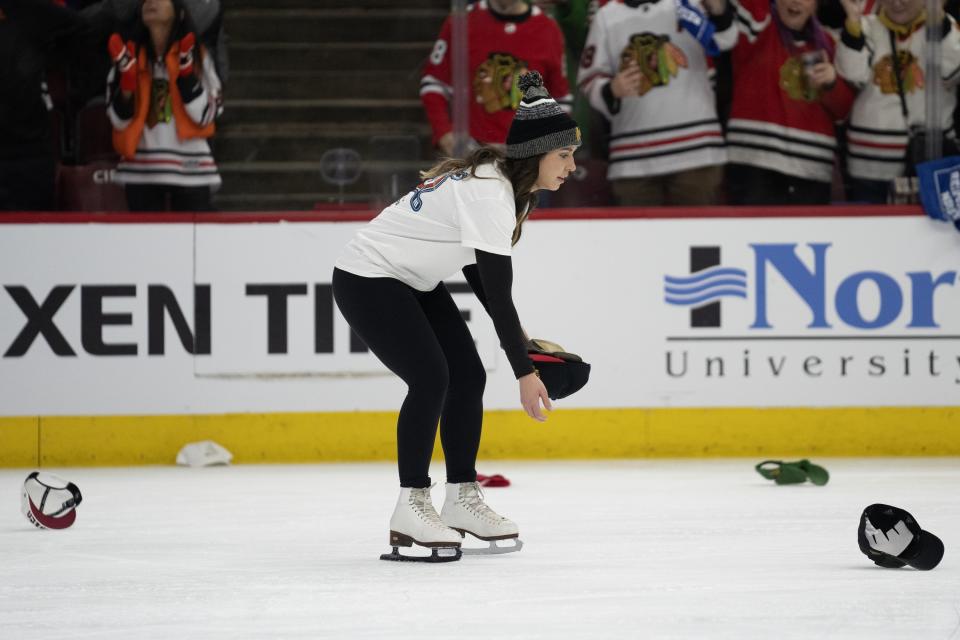 Hats are collected off the ice after Chicago Blackhawks right wing Patrick Kane scored a hat trick during the second period of an NHL hockey game against the Toronto Maple Leafs, Sunday, Feb. 19, 2023, in Chicago. The goal was initially waved off before being declared good. (AP Photo/Erin Hooley)