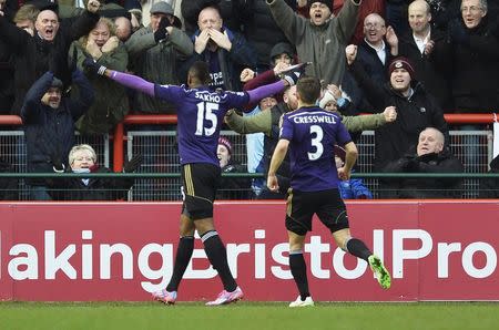 West Ham United's Diafra Sakho (L) celebrates with team mate Aaron Cresswell after scoring a goal against bristol City during their FA Cup fourth round soccer match at the Ashton Gate Stadium in Bristol, southern England January 25, 2015. REUTERS/Toby Melville (BRITAIN - Tags: SPORT SOCCER)