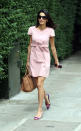 <p>A pretty pink day dress taken to the next level with mismatched shoes. <i>(Photo by Splash News)</i></p>