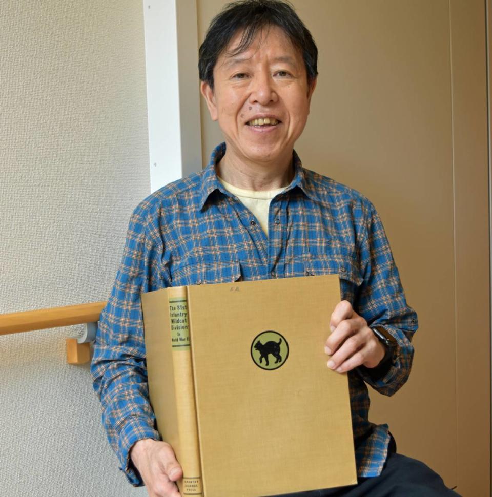 Japanese historian Yuki Kimura holds a copy of the book in which he found a 1945 letter that Edward “Eddie” Borradori of Cayucos wrote to his parents. The initials E.B. are seen at the top of the book’s cover.