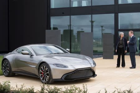 Britain's Prime Minister Theresa May and Aston Martin's Chief Executive Andy Palmer stand next to a car in Barry, Wales March 29, 2018. Stefan Rousseau/Pool via Reuters