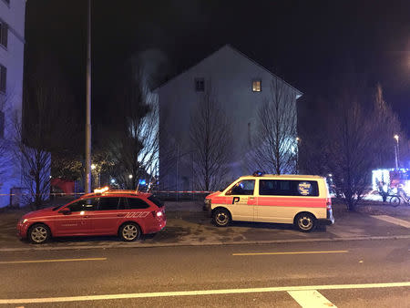 Operational vehicles of police and firefighters are seen in front of a house where six people were killed in an apartment fire early on Monday morning, police said, while an unspecified number of others caught in the blaze were taken to the hospital in Solothurn, Switzerland November 26, 2018. Polizei Kanton Solothurn/Handout via REUTERS.