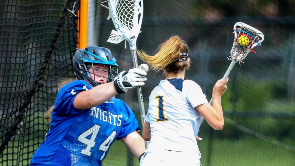 Lexington Catholic goalie Annie Malley (44) stops a shot from Sayre’s Danica Porter (1) during overtime in Commonwealth Lacrosse League girls’ championship match.