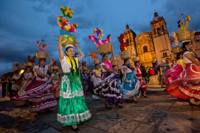 Mandatory Credit: Photo by ZUMA/REX Shutterstock (3310424f) Young women dressed in traditional costumes parade in a comparsas past the Santo Domingo de Guzman Church during the Day of the Dead Festival. Day Of The Dead Festival in Oaxaca, Mexico - 02 Nov 2013  