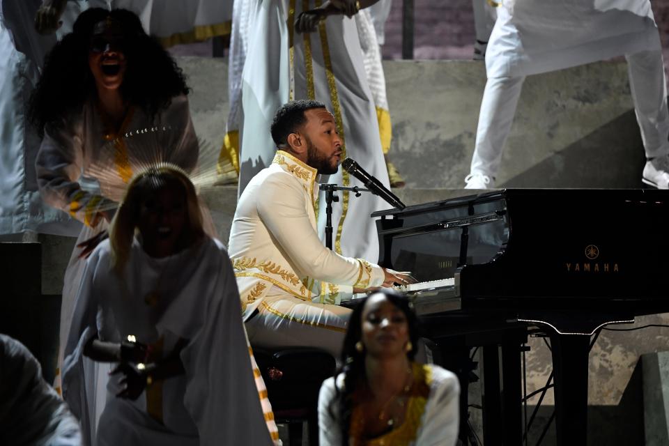 John Legend plays piano during a tribute to rapper Nipsey Hussle, who died in 2019.