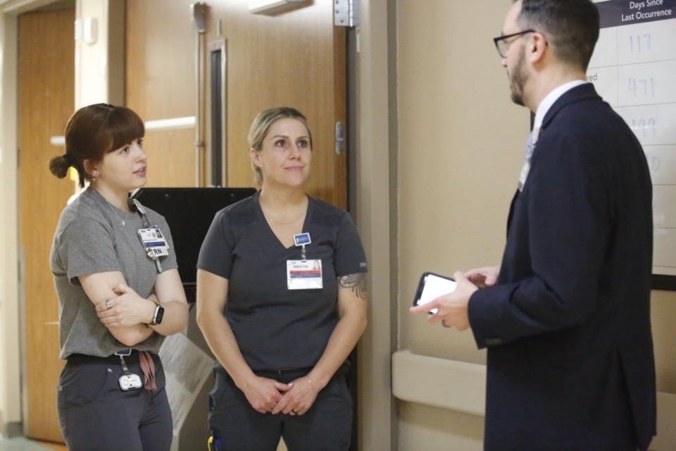 Chief nursing officer Adam Meier, right, tries to visit various floors at University of Kansas Health System St. Francis Campus. Liz Wood, left, and Kristin Bayes talk about their daily rounds on the hospital's third floor.