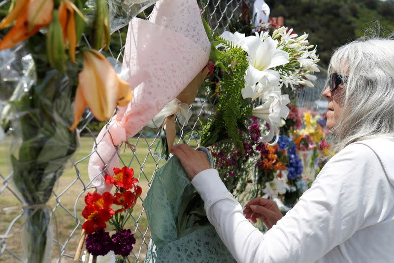 A woman looks at a memorial at the harbour in Whakatane, following the White Island volcano eruption in New Zealand