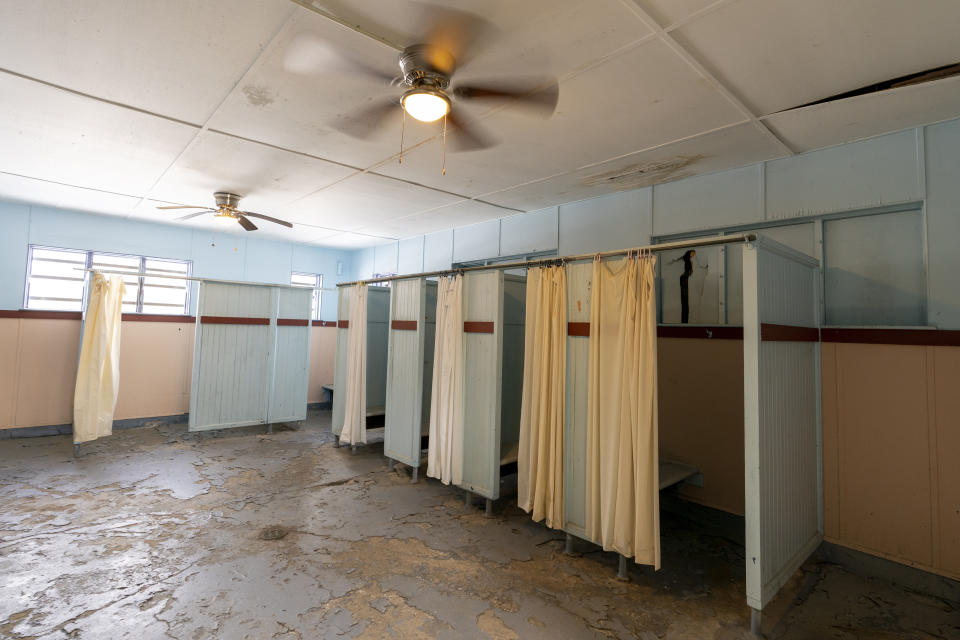 The woman's changing area at the Spratt Park pool house in Poughkeepsie, N.Y., is in need of repair, on Tuesday, Jan. 25, 2022. Poughkeepsie was rated by the New York comptroller as the state’s most financially stressed community in 2020. The more than $20 million it is getting from the American Rescue Plan cannot be used to wipe out the deficit, but the city plans to make major improvements to parks and swimming pools, including a complete rebuild of a run-down bathhouse that has been relying on portable toilets. (AP Photo/Mary Altaffer)