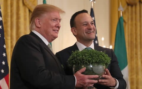 Irish Taoiseach Leo Varadkar, presents US President Donald Trump, with a bowl of Shamrocks during the annual St Patrick's Day ceremony at the White House in Washington D.C. - Credit: Brian Lawless/PA