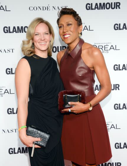 Robin Roberts and girlfriend Amber Laign attend a formal event